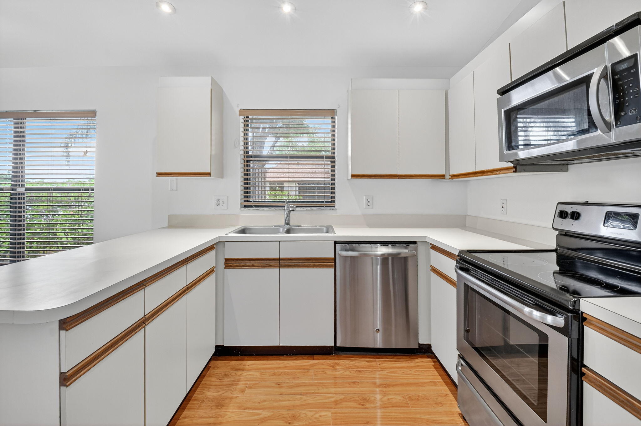 73 Vía De Casas Norte Boynton Beach, FL 33426 - Photo 7 of 60 a kitchen with stainless steel appliances granite countertop a sink stove and microwave