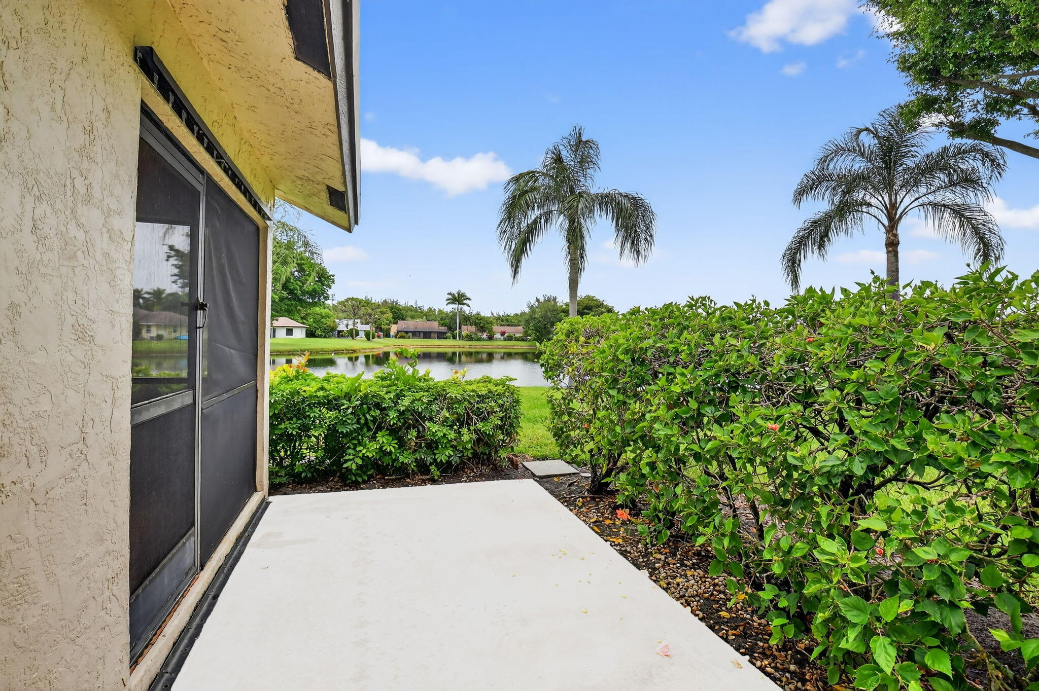 73 Vía De Casas Norte Boynton Beach, FL 33426 - Photo 8 of 60 a couple of potted plants in front of a building