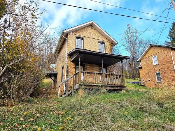 a backyard of a house with table and chairs