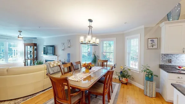 a view of a dining room with furniture window and wooden floor