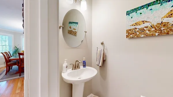 a bathroom with a sink mirror and toilet
