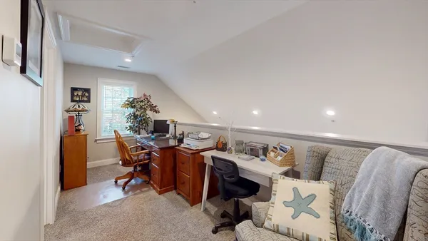 a living room with furniture a dining table and a potted plant