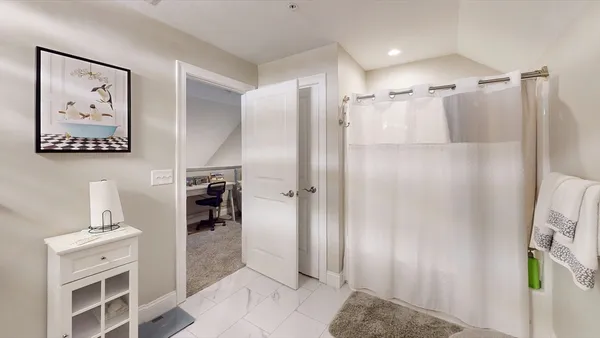 a bathroom with a shower and a sink
