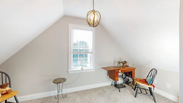 a view of a room with a window and furniture