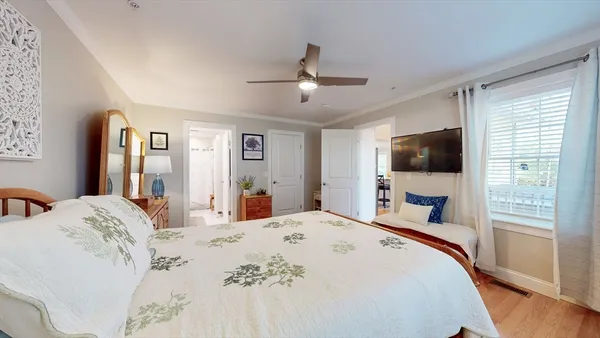 a bedroom with a bed and a flat screen tv