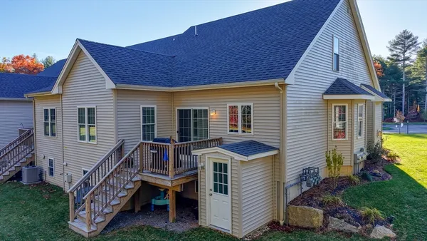 a front view of house with yard and deck