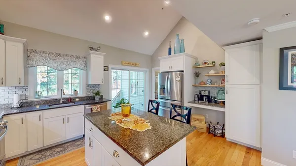 a kitchen with stainless steel appliances granite countertop a sink stove and cabinets