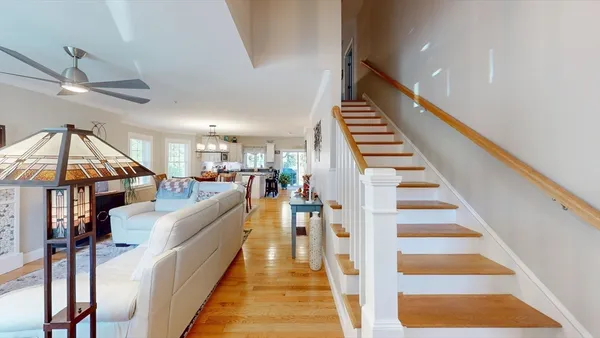 a view of entryway and hall with wooden floor