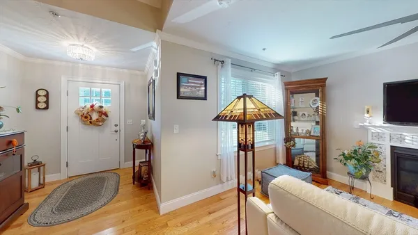 a view of a livingroom with furniture a fireplace and wooden floor
