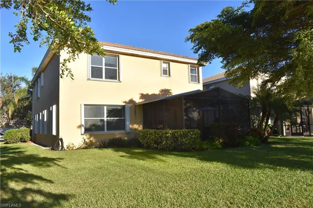 an aerial view of a house with outdoor space and lake view