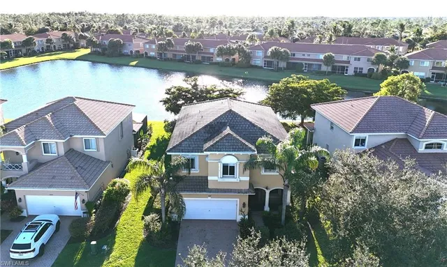 an aerial view of residential houses with outdoor space and swimming pool