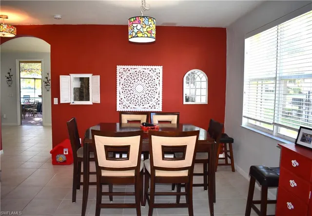 a dining room with furniture and window