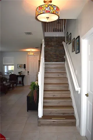 a view of a livingroom with furniture and staircase