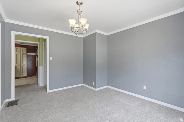 378 West 200 South Bountiful, UT 84010 - Photo 8 of 32 Light gray walls complement white crown molding and baseboards in this room featuring a brushed nickel chandelier