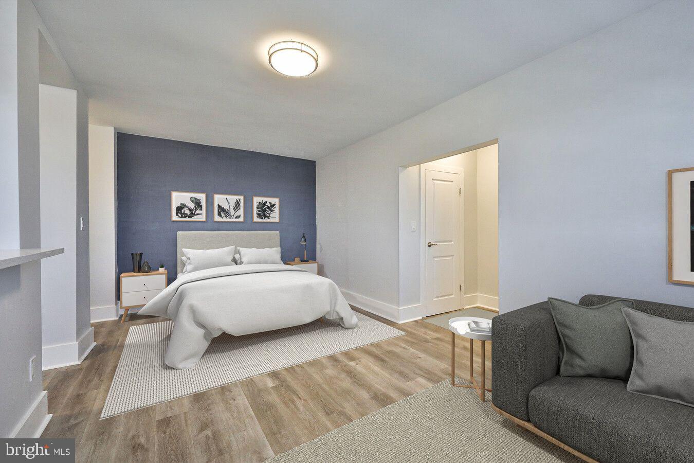 4247 Locust Street, Unit 1B117 Philadelphia, PA 19104 - Photo 6 of 38 a bedroom with a bed and a couch