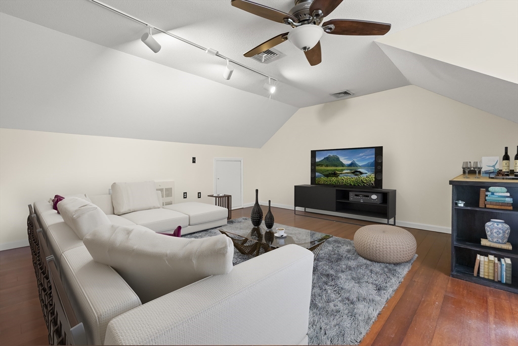 4203 Woodbridge Road, Unit 4203 Peabody, MA 01960 - Photo 13 of 31 a living room with furniture and a flat screen tv