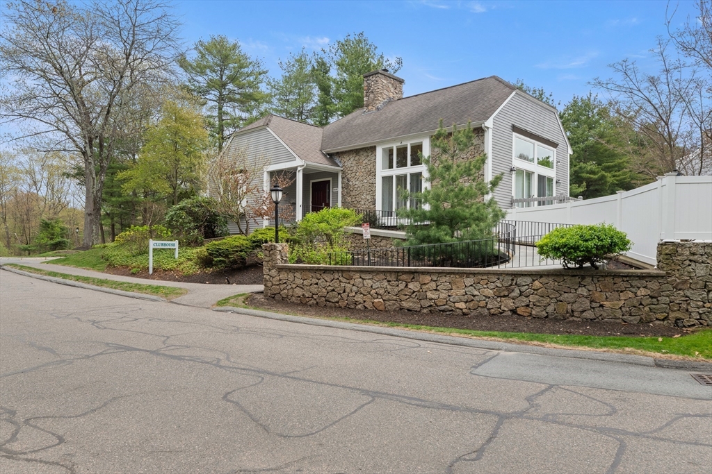 4203 Woodbridge Road, Unit 4203 Peabody, MA 01960 - Photo 25 of 31 a front view of a house with a yard and potted plants