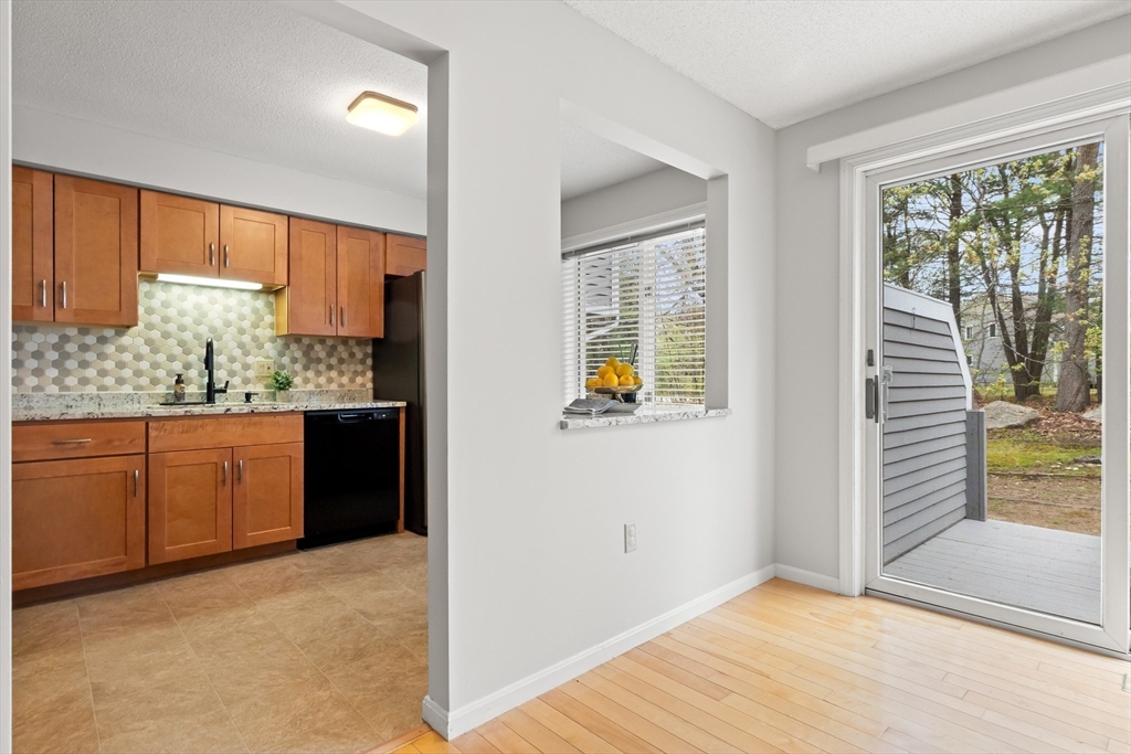4203 Woodbridge Road, Unit 4203 Peabody, MA 01960 - Photo 7 of 31 a view of kitchen with wooden floor and window