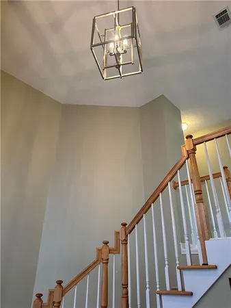 a view of staircase with railing and white walls