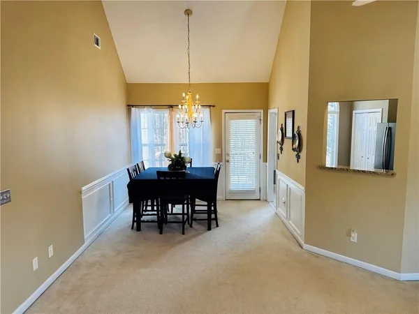 a view of a dining room with furniture and chandelier