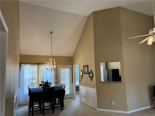 a view of a dining room with furniture and chandelier