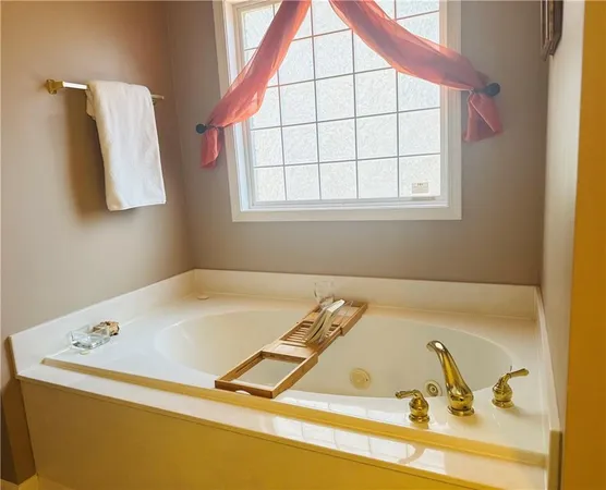 a bathroom with a tub and a window