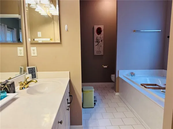 a bathroom with a tub sink and toilet