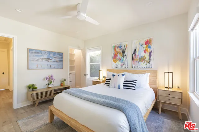 a bedroom with a bed and a painting on the wall