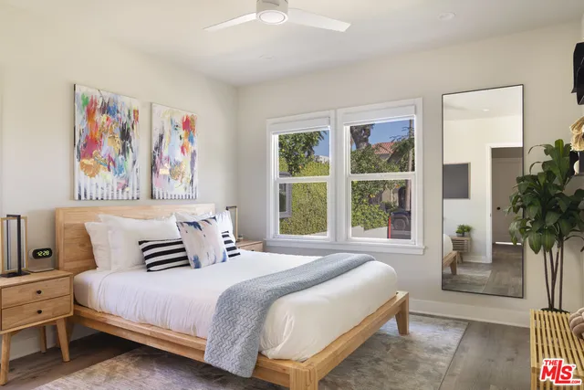 a bedroom with a bed and a painting on the wall