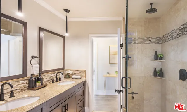 a bathroom with a granite countertop sink mirror and shower