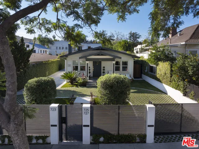 a view of a house with wooden fence