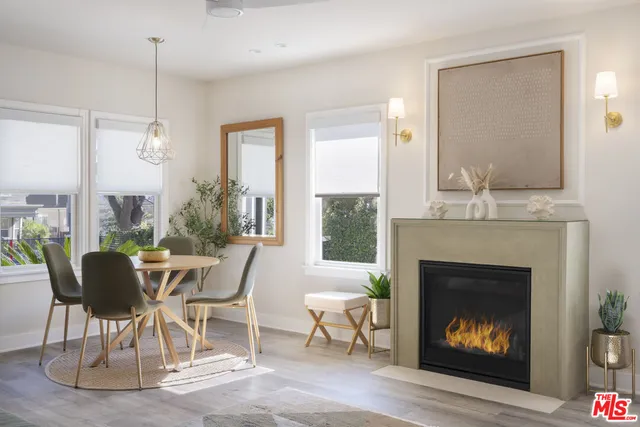 a dining room with furniture a fireplace and a chandelier