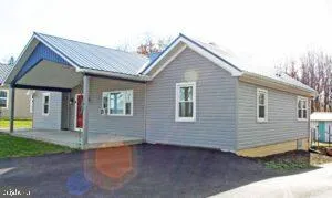 a view of a house with wooden fence