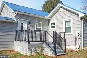 a view of a house with wooden fence