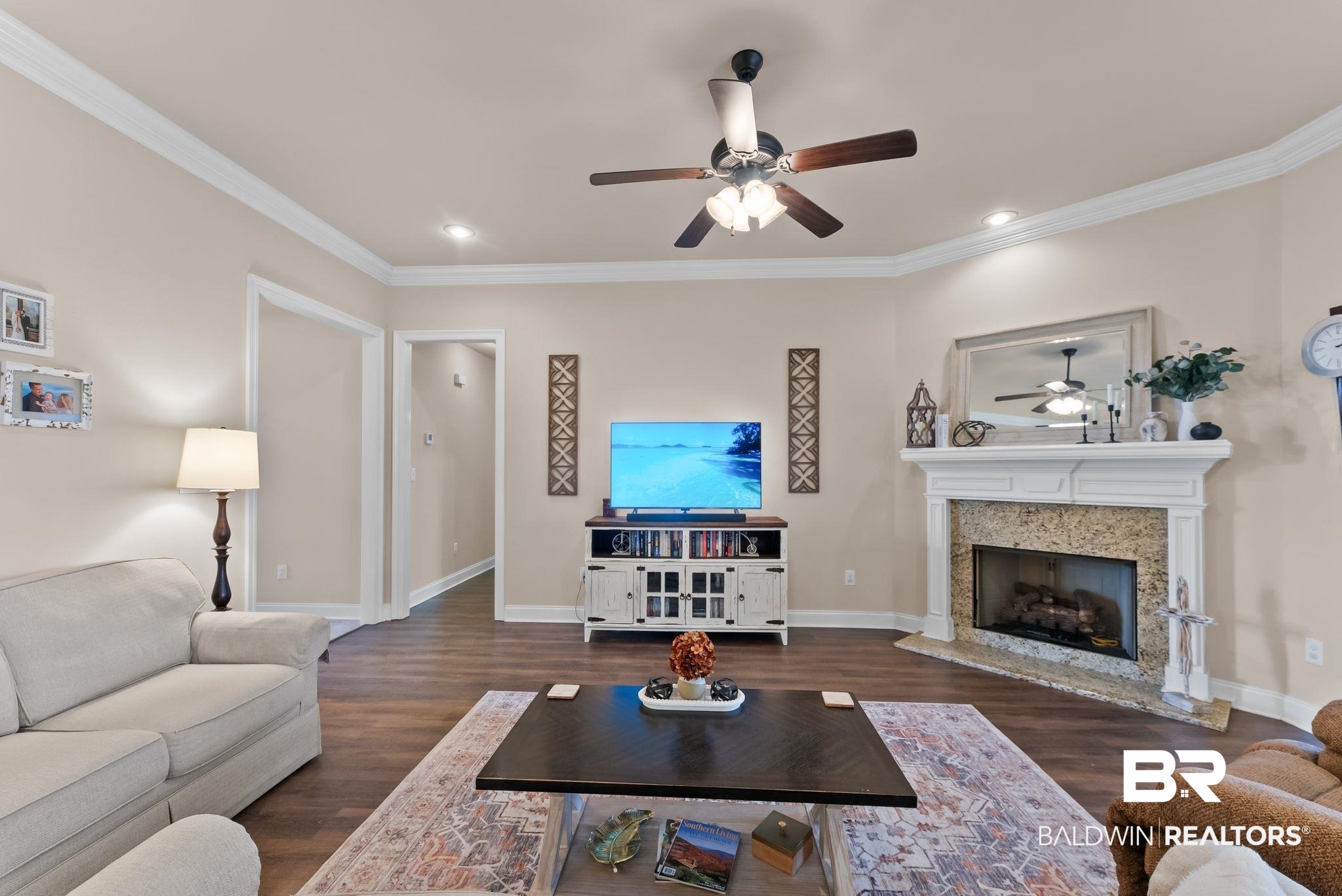 7015 Rocky Rd Loop Gulf Shores, AL 36542 - Photo 9 of 41 Living room featuring ceiling fan, dark wood-style floors, a high end fireplace, crown molding, and recessed lighting