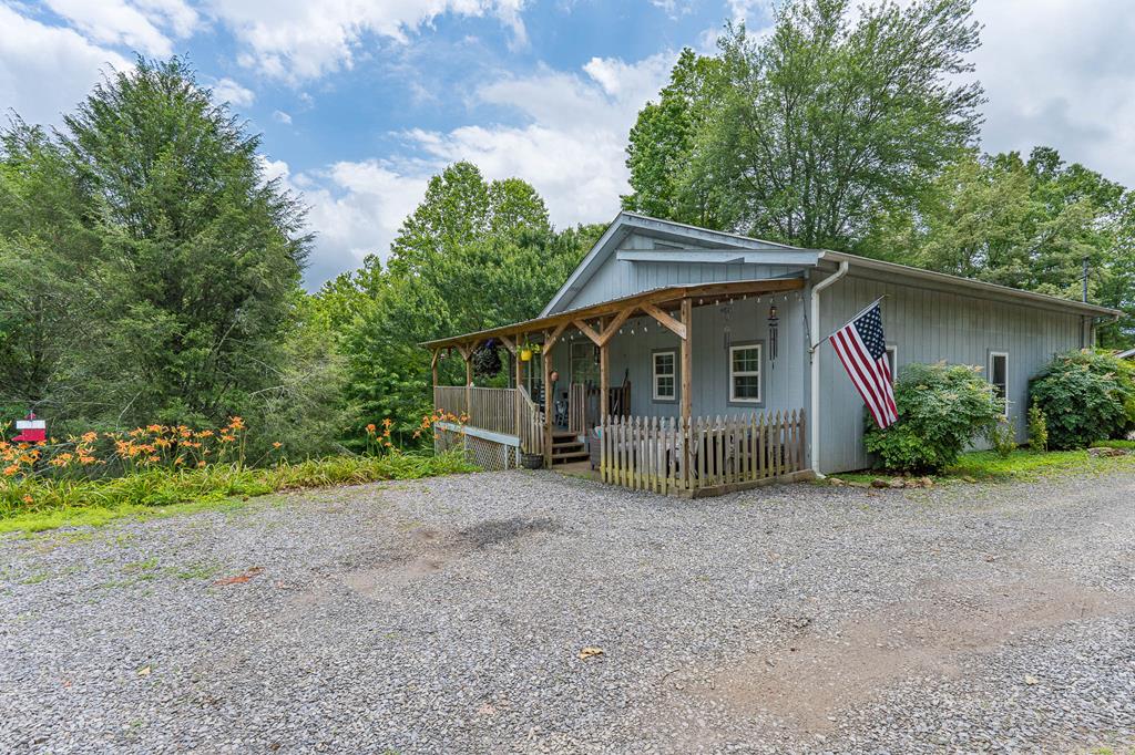 a view of a house with a yard and plants