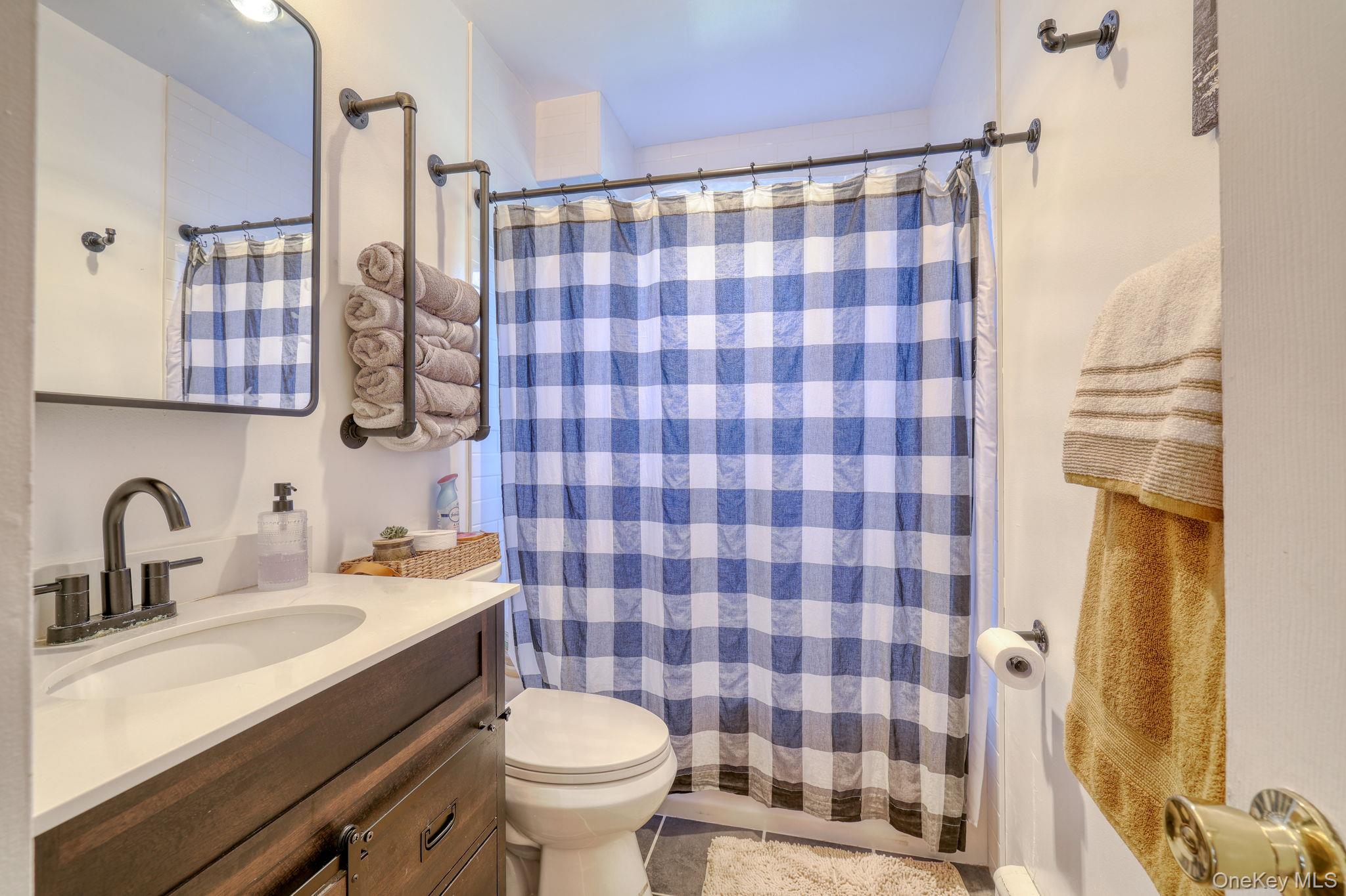 143 Plains Road Walden, NY 12586 - Photo 14 of 36 Full bath featuring vanity, curtained shower, and tile patterned flooring