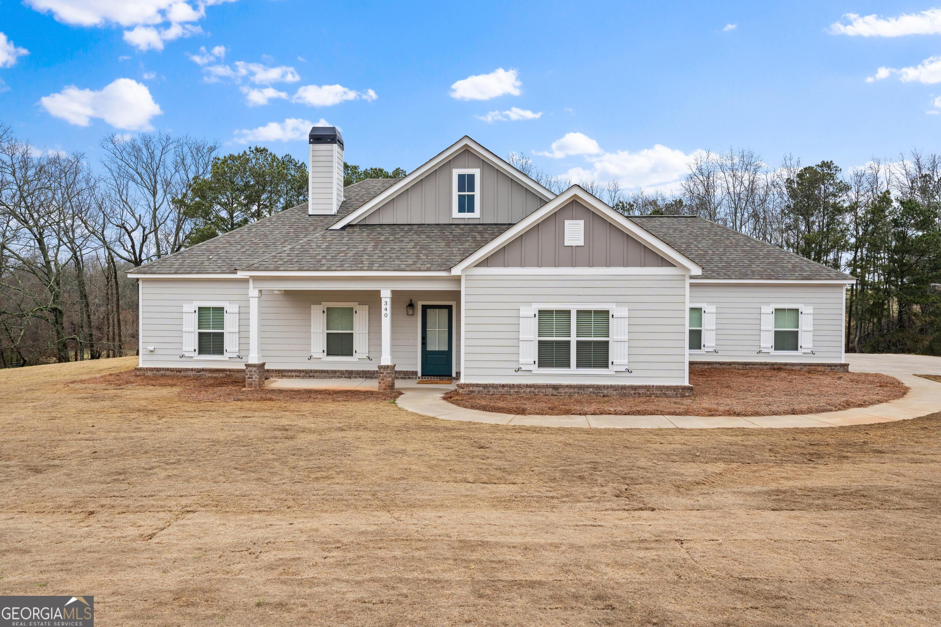 340 Happy Hollow Road Roopville, GA 30170 - Photo 1 of 22 a front view of a house with a yard and garage