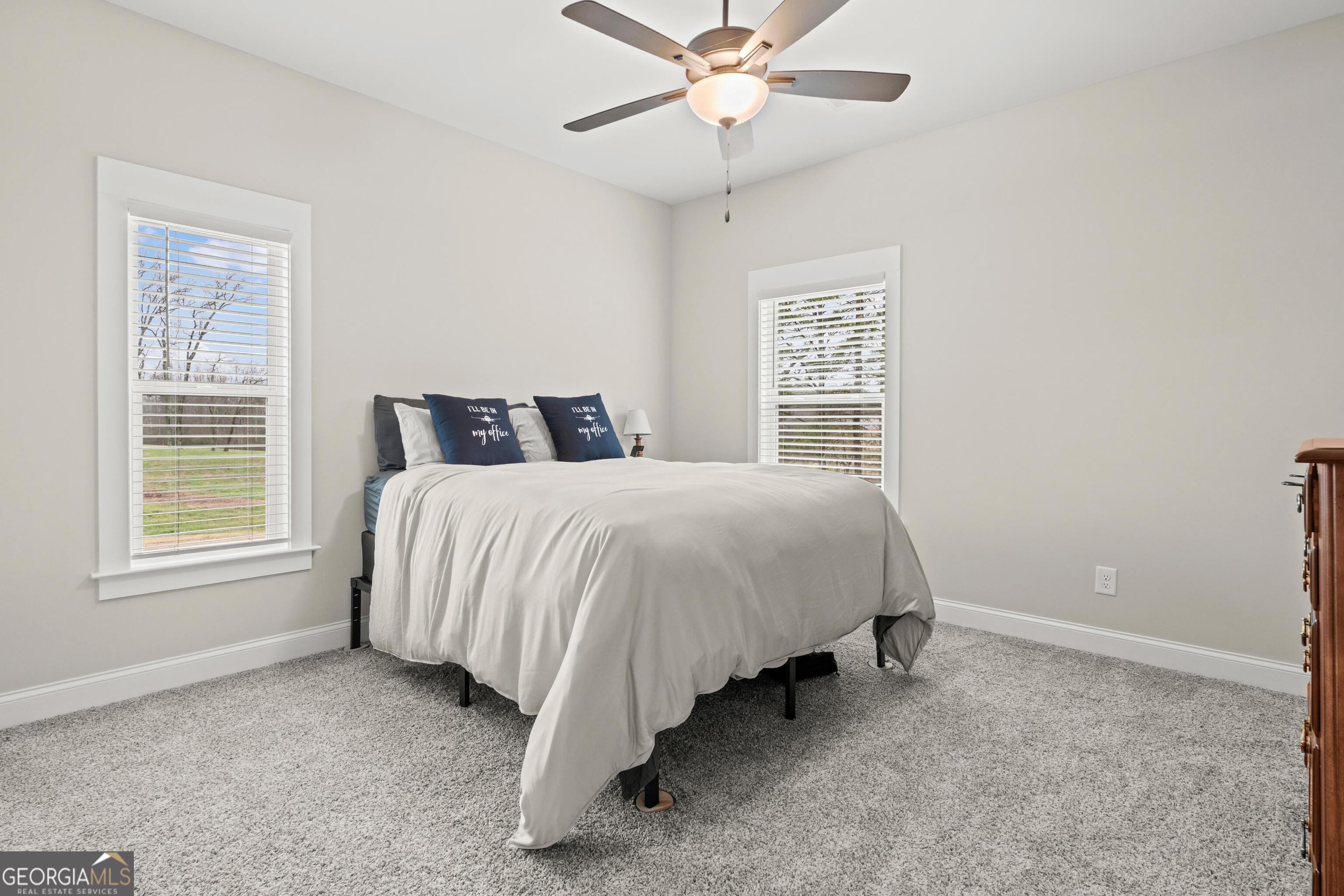 340 Happy Hollow Road Roopville, GA 30170 - Photo 11 of 22 a spacious bedroom with a bed and a window