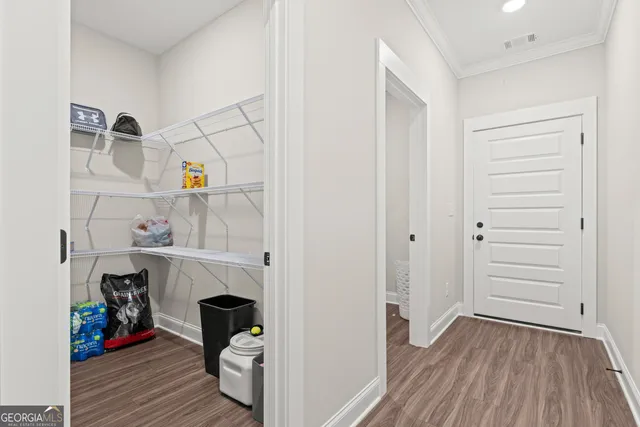 a view of room with wooden floor and closet