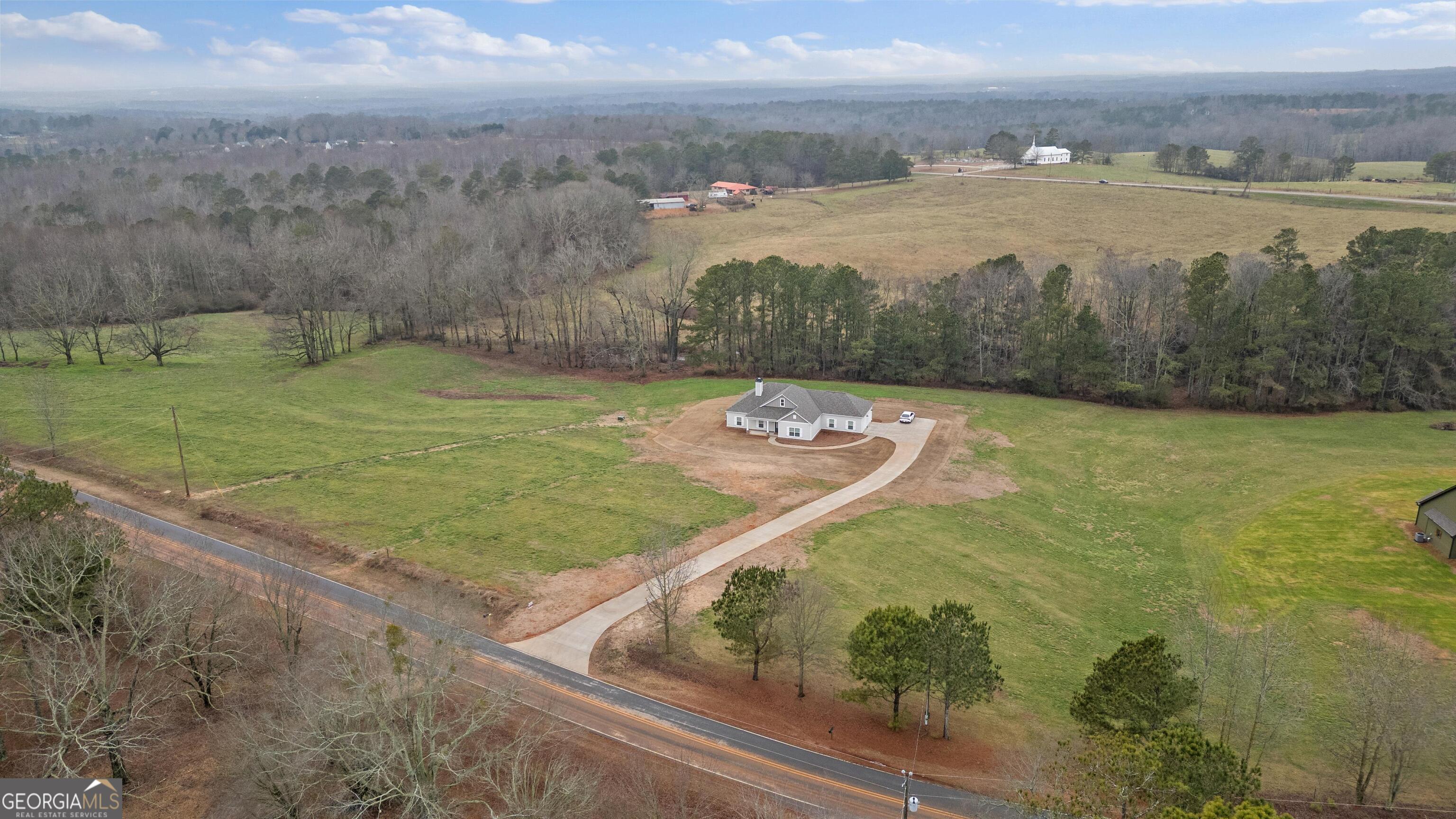 340 Happy Hollow Road Roopville, GA 30170 - Photo 20 of 22 a view of a lake with a yard