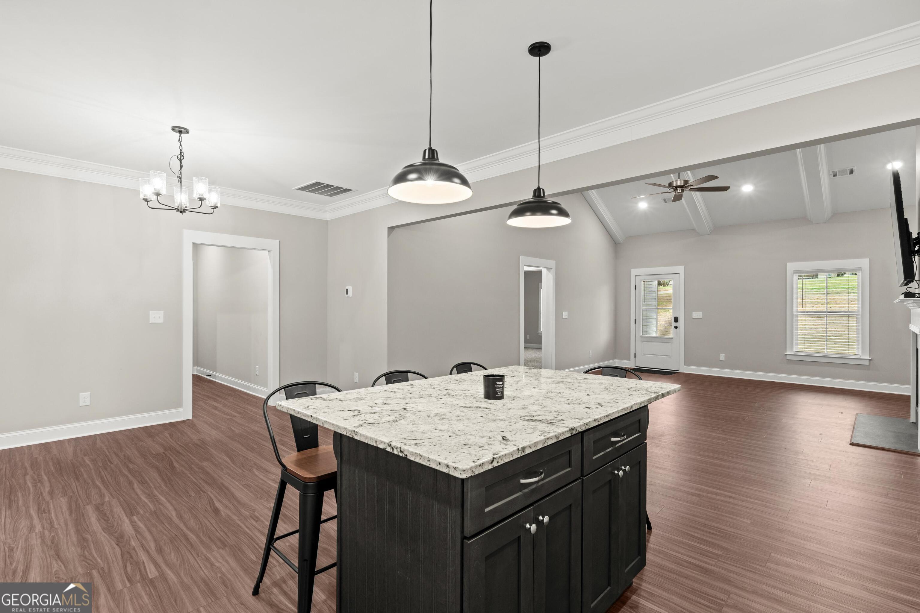 340 Happy Hollow Road Roopville, GA 30170 - Photo 5 of 22 a kitchen with a table chairs and wooden floor