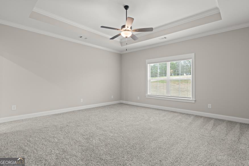 340 Happy Hollow Road Roopville, GA 30170 - Photo 8 of 22 an empty room with a chandelier fan and windows