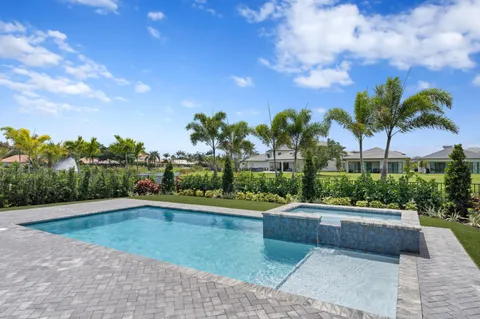a view of a swimming pool with a yard