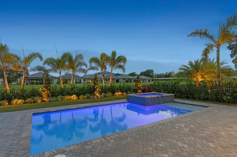 a view of swimming pool outdoor seating and city view