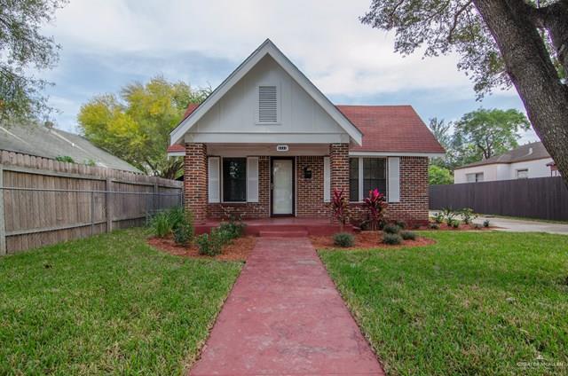 a view of a house with a yard and table and chairs