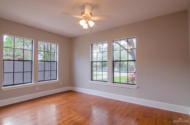 1112 North 16th Street McAllen, TX 78501 - Photo 11 of 21 an empty room with wooden floor and windows