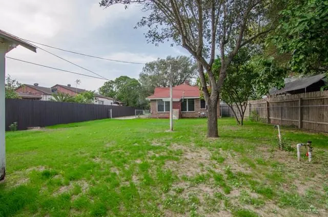 a view of house with backyard