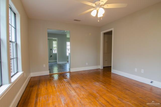 1112 North 16th Street McAllen, TX 78501 - Photo 3 of 21 a view of an empty room with wooden floor and a window