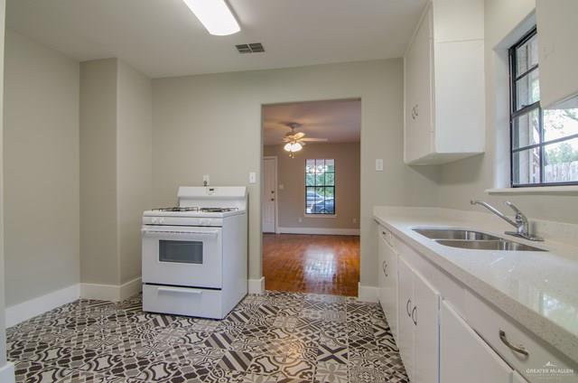 1112 North 16th Street McAllen, TX 78501 - Photo 8 of 21 a kitchen with a sink stove and cabinets